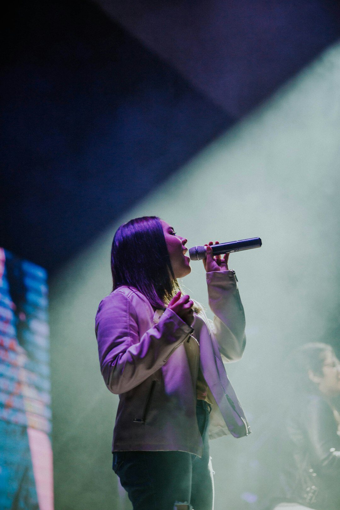 woman singing on stage